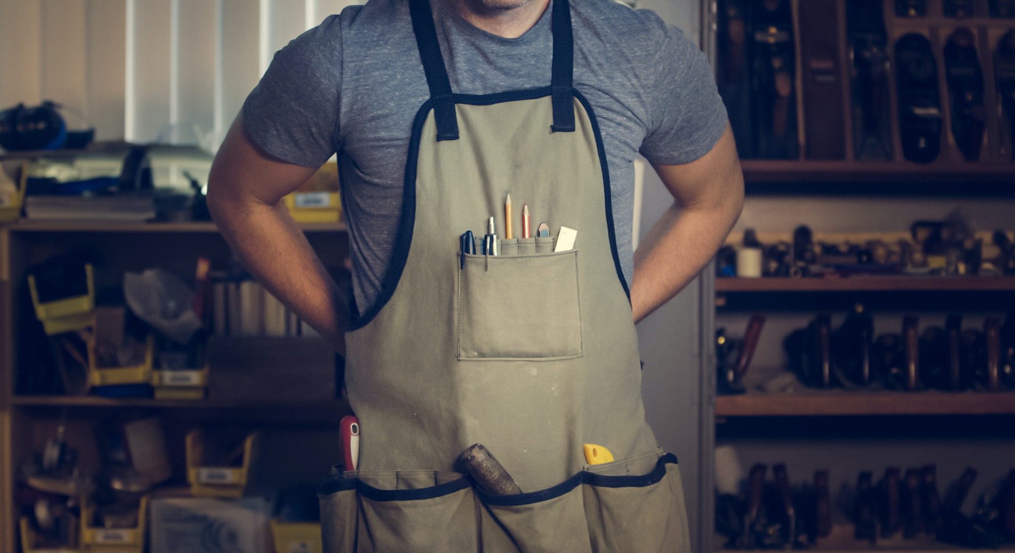 Handyman with apron filled with tools